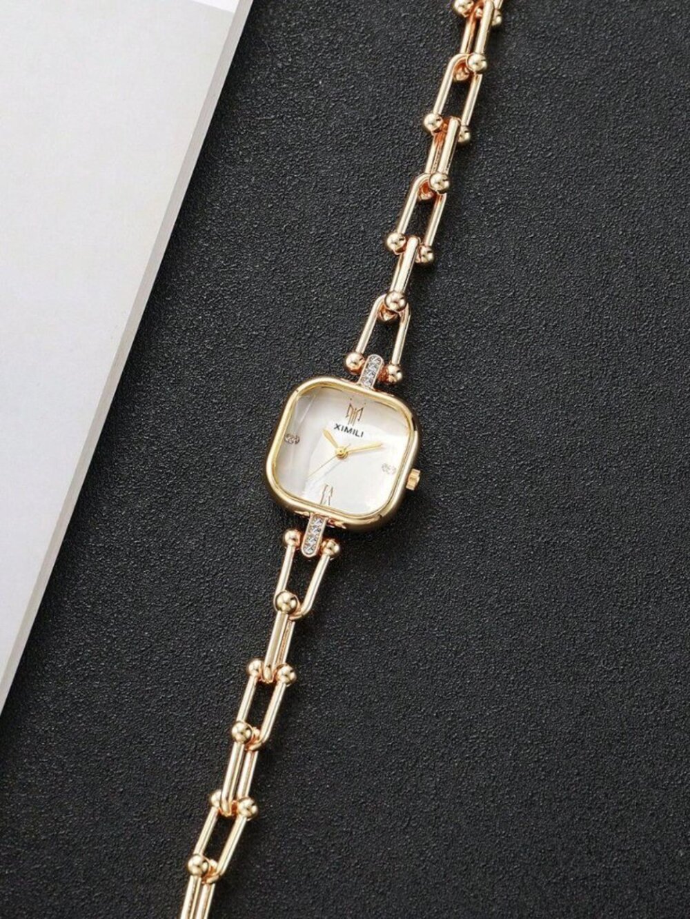 Woman's fashion gold watch, white face